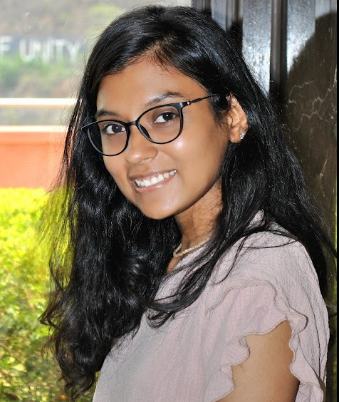 Portrait of Himanshi Sheth in professional attire with soft lighting and neutral background